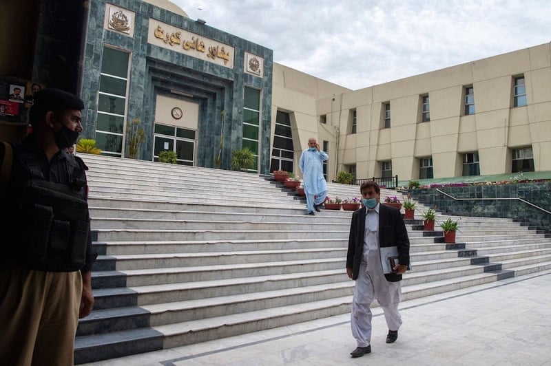 a lawyer walks past in front of the peshawar high court building photo afp