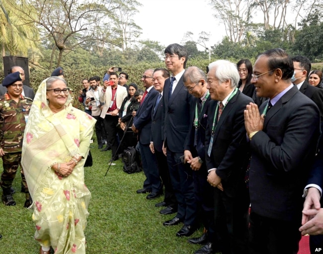 In this photograph released by Bangladesh Prime Minister's office, Prime Minister Sheikh Hasina, left, arrives to address a press conference following her election victory in Dhaka, Bangladesh, Jan. 8, 2024.